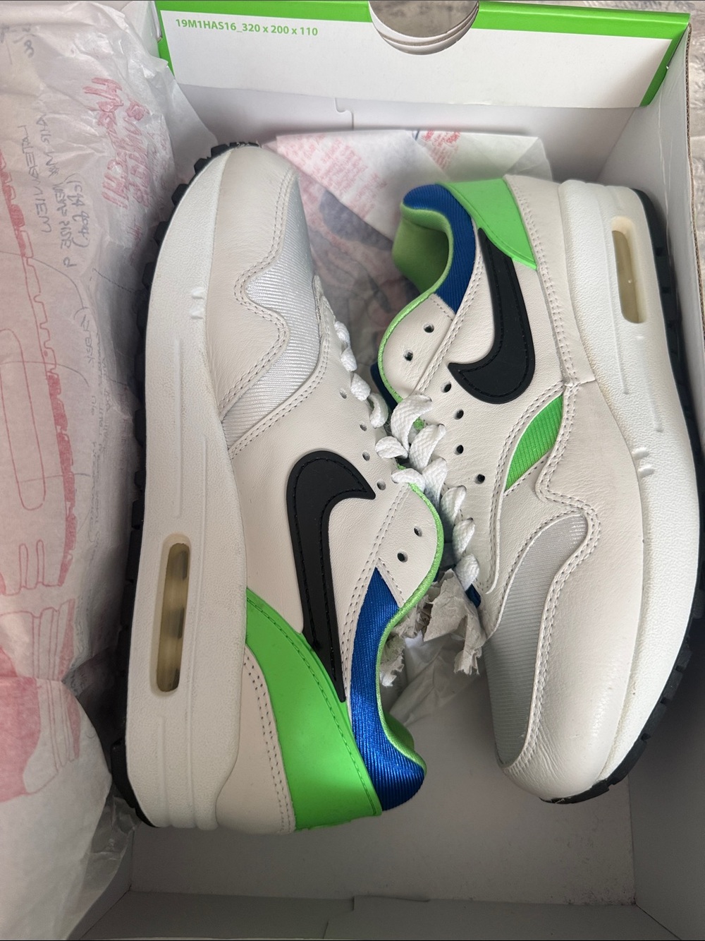 Nike Kids White Sneakers with Black Swoosh and Green & Blue Accents